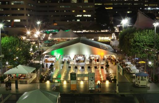 Large tent on Crown Center square at night with Irish Flag colored lighting