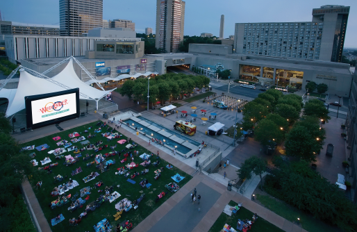 WeekEnder Event on Crown Center Square including large screen people in chairs and blankets, food trucks and Shops and Hotel in Background