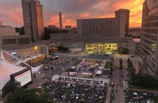 WeekEnder Event on Crown Center Square including large screen people in chairs and blankets, food trucks and Shops and Hotel in Background