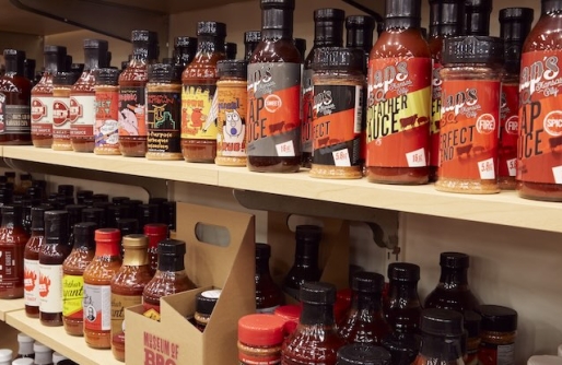 Wooden Shelves Lines with Bottles of BBQ Sauce
