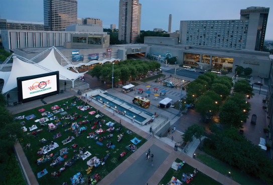 WeekEnder Event on Crown Center Square including large screen people in chairs and blankets, food trucks and Shops and Hotel in Background