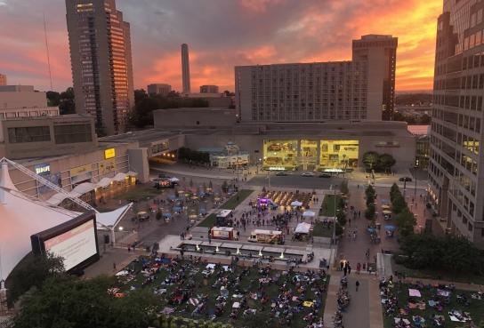 WeekEnder Event on Crown Center Square including large screen people in chairs and blankets, food trucks and Shops and Hotel in Background
