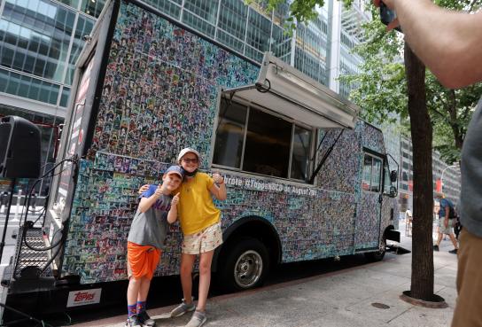 Children in front of TOPPS baseball card truck