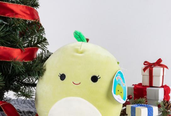 Squishmallow Stuffed Ashley next to tree