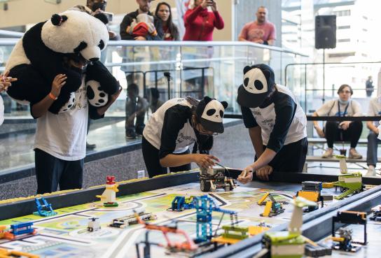 Students in Panda Costumes at game table