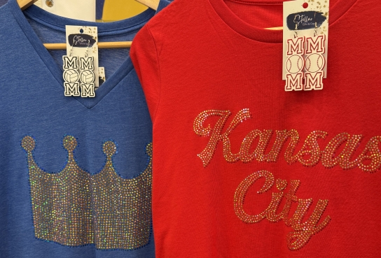 Blue Shirt with Crown and Red Shirt with Kansas City on hangars with matching earrings