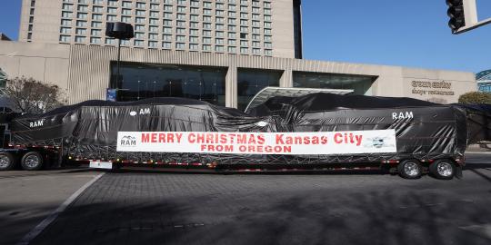 Oversized Semi with Trailer Holding the Mayor's Tree, Wrapped in Greeting