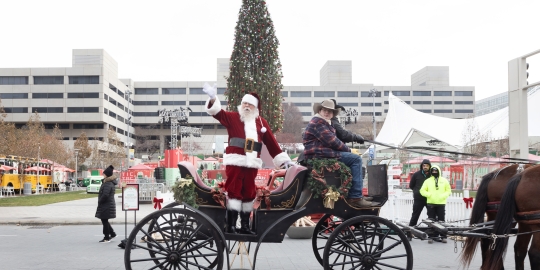 Santa on wagon waiving 