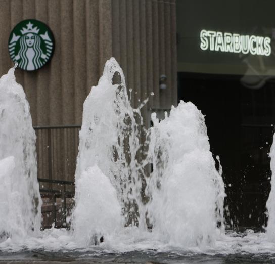 View of Starbucks signage through fountain 